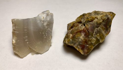 Two pieces of agate, one light gray and one darker olive