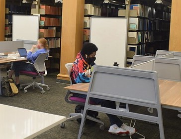 Students wearing masks in the library