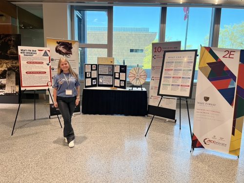 Student stands with multiple information displays at ACCelerate Festival