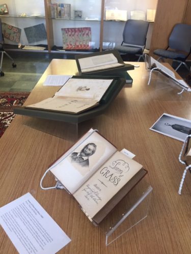 Books open in cradles displayed on a table