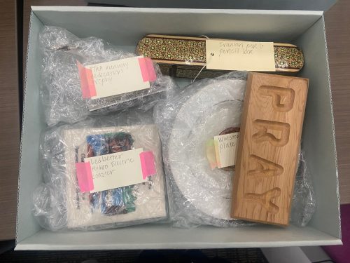 Four artifacts from the Richard Burr collection rest in an archival box