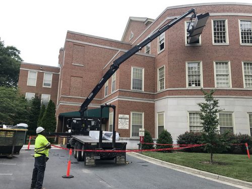 photograph of delivery of metal studs to ZSR Library, through the 6th floor window of the Wilson wing.