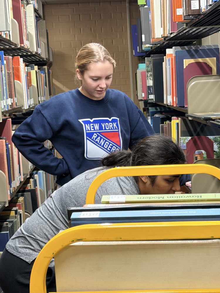 Student workers Lulu Clark and Safa Akhter on Reynolds 4 working on moving the N's from Reynolds 6 to Reynolds 4.