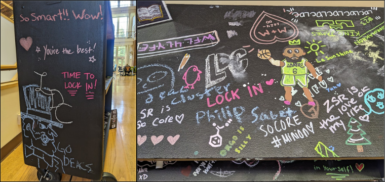 A chalkboard book truck covered in colorful chalk drawings and messages, featuring phrases like "LOCK IN" and "YOU GOT THIS".