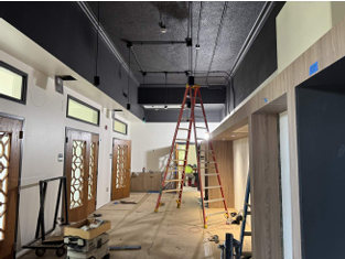 Interior of the Writing Center under renovation with a ladder and construction equipment.